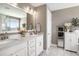 Bright bathroom features double sinks, white cabinets, and a large mirror at 624 Sienna Way, Summerville, SC 29486