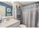 Cozy bathroom features a shower and tub combination with a white vanity and a blue textured wall at 624 Sienna Way, Summerville, SC 29486