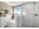 Elegant bathroom features a glass-enclosed shower, a separate tub, and white subway tile walls at 624 Sienna Way, Summerville, SC 29486