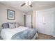 Clean bedroom featuring a bed with a blue blanket, white closets and a window with natural light at 624 Sienna Way, Summerville, SC 29486