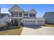 Beautiful two-story home boasts a welcoming porch and a convenient three-car garage at 624 Sienna Way, Summerville, SC 29486