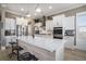 Spacious kitchen featuring a large island, white cabinets, and stainless steel appliances at 624 Sienna Way, Summerville, SC 29486