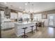 Bright, modern kitchen with a large center island, pendant lighting, and stainless steel appliances at 624 Sienna Way, Summerville, SC 29486