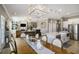 Open concept living area features a kitchen island, dining space, and a cozy living room at 624 Sienna Way, Summerville, SC 29486
