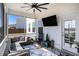 Inviting screened porch with comfortable seating, ceiling fan, and an outdoor TV at 624 Sienna Way, Summerville, SC 29486