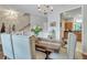 Beautiful dining area with modern chandelier, stairs in background and lots of space to enjoy a meal at 711 Hemingway Cir, Summerville, SC 29483