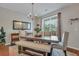 Charming dining room with a large window, modern chandelier and bench seating for guests at 711 Hemingway Cir, Summerville, SC 29483