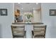 View of kitchen bar with granite counters, two stools, and decor, plus opening to view dining area beyond at 711 Hemingway Cir, Summerville, SC 29483