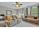 Comfortable living room with ceiling fan, large windows, and comfortable seating at 711 Hemingway Cir, Summerville, SC 29483