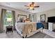 Spacious main bedroom with large bed, ceiling fan, natural light, and ensuite bath at 711 Hemingway Cir, Summerville, SC 29483