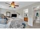 Main bedroom with large bed, ceiling fan, natural light, and access to ensuite bath and closets at 711 Hemingway Cir, Summerville, SC 29483