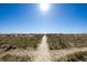 Sandy path with beach grass that leads to a sunny beach and blue skies at 7600 Palmetto Drive # D-222, Isle of Palms, SC 29451