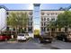 Condo building exterior with parking spaces, landscaping, and a modern facade at 7600 Palmetto Drive # D-222, Isle of Palms, SC 29451