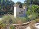 Welcoming 'Wild Dunes' community sign surrounded by tropical plants and greenery at 7600 Palmetto Drive # D-222, Isle of Palms, SC 29451