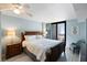 Primary bedroom with private balcony access, beach-themed accents, and wood furnishings at 7600 Palmetto Drive # D-222, Isle of Palms, SC 29451