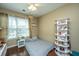Bedroom with hardwood floors, a fan, natural light, and display shelves at 7977 Shadow Oak Dr, North Charleston, SC 29406