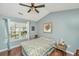 Cozy bedroom with a vaulted ceiling, wood floors, and a large window at 7977 Shadow Oak Dr, North Charleston, SC 29406