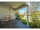 Inviting covered patio with a ceiling fan, tiled floor and orange bike at 7977 Shadow Oak Dr, North Charleston, SC 29406