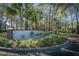 Oak Bluff entrance sign, brick base, and attractive landscaping at 7977 Shadow Oak Dr, North Charleston, SC 29406