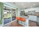 Kitchen featuring stainless appliances and granite island with bar stool seating, with sliding glass doors to the backyard at 7977 Shadow Oak Dr, North Charleston, SC 29406