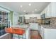 Bright kitchen with stainless steel appliances and a granite island with bar stool seating at 7977 Shadow Oak Dr, North Charleston, SC 29406