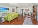 Open-concept living room showcases hardwood floors, a TV, and seamless flow to the dining area at 7977 Shadow Oak Dr, North Charleston, SC 29406