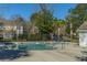 Community pool with steps into the pool and wrought iron fence at 7977 Shadow Oak Dr, North Charleston, SC 29406