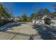 Community pool surrounded by spacious concrete deck and wrought iron fence at 7977 Shadow Oak Dr, North Charleston, SC 29406