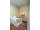 Staircase with wood flooring, a white banister, a hanging light fixture, and framed artwork at 7977 Shadow Oak Dr, North Charleston, SC 29406