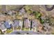 Aerial view of three homes along a creek features long driveways and mature landscaping at 8585 Refuge Pointe Cir, North Charleston, SC 29420