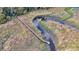Aerial view of a wooden walking bridge stretching across the winding creek and marshland at 8585 Refuge Pointe Cir, North Charleston, SC 29420