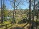 Private backyard with fence overlooking a tranquil river and lush, mature trees with Spanish moss at 8585 Refuge Pointe Cir, North Charleston, SC 29420