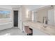 Bright bathroom features a walk in shower, soaking tub, vanity, and large mirror illuminated by wall sconces at 8585 Refuge Pointe Cir, North Charleston, SC 29420