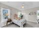 Well-lit bedroom with soft carpet, decorative accents, and a large window for natural light at 8585 Refuge Pointe Cir, North Charleston, SC 29420