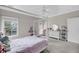 Comfortable bedroom featuring a four-poster bed, ceiling fan, and an ensuite balcony with sliding glass door at 8585 Refuge Pointe Cir, North Charleston, SC 29420