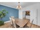 Comfortable dining area featuring blue accent wall, hardwood floors, and access to kitchen at 8585 Refuge Pointe Cir, North Charleston, SC 29420