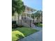 Charming two-story home with a brick staircase and double porches, framed by palm trees and green lawn at 8585 Refuge Pointe Cir, North Charleston, SC 29420