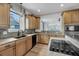 Well-lit kitchen with wood cabinets, granite countertops and stainless steel appliances at 8585 Refuge Pointe Cir, North Charleston, SC 29420