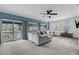 Inviting living room with large sectional, ceiling fan, and sliding glass doors to the outside porch at 8585 Refuge Pointe Cir, North Charleston, SC 29420