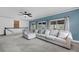 Spacious living room features a large sectional, neutral carpet, and lots of natural light at 8585 Refuge Pointe Cir, North Charleston, SC 29420