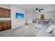 Entertainment area features a wet bar, mounted TV, and plush sectional seating, offering comfort and style at 8585 Refuge Pointe Cir, North Charleston, SC 29420