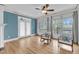 Living room featuring natural light, hardwood floors, and access to outdoor balcony at 8585 Refuge Pointe Cir, North Charleston, SC 29420
