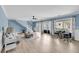 Open-concept living room with hardwood floors, comfortable furniture, and sliding glass doors to the outside porch at 8585 Refuge Pointe Cir, North Charleston, SC 29420