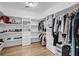 This walk-in closet has custom shelving, shoe racks, drawers, hanging racks and natural hardwood floors at 8585 Refuge Pointe Cir, North Charleston, SC 29420