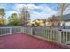 The wood deck overlooks the backyard and is enclosed with white railings at 8849 Kellum Dr, North Charleston, SC 29420