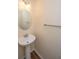 Bathroom with a pedestal sink, oval mirror, and a towel rack at 8849 Kellum Dr, North Charleston, SC 29420