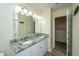 Bright bathroom features a double sink with granite countertops and large mirror at 8849 Kellum Dr, North Charleston, SC 29420
