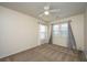 This room features neutral walls and carpet along with two windows and a ceiling fan at 8849 Kellum Dr, North Charleston, SC 29420