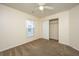 This bedroom features neutral walls and carpet, along with a window and a closet at 8849 Kellum Dr, North Charleston, SC 29420