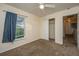 Inviting bedroom with a ceiling fan and a closet with sliding doors for convenient storage at 8849 Kellum Dr, North Charleston, SC 29420